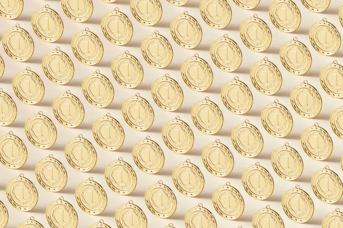 Seamless pattern featuring gold medals on a flat background, ideal for sports themes.